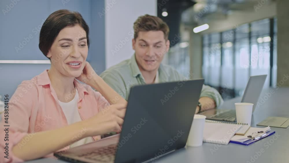 Marketing specialists discussing project details, talking in office, teamwork Marketing specialists discussing project details, talking in office, teamwork