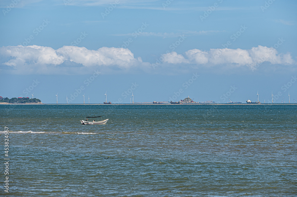 On a sunny day in summer, the speedboat drove fast in the blue sea