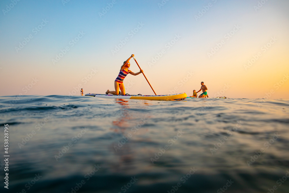sup surfing in the sea