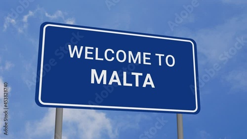 Welcome to Malta Road Sign on Clear Blue Sky with Rapid Moving Clouds photo