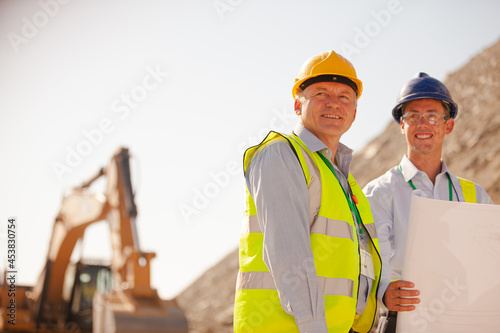 Business people and workers standing in quarry