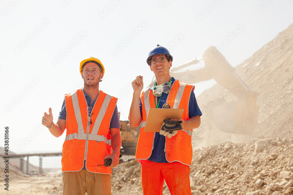 Worker standing by machinery on site Worker standing by machinery on site