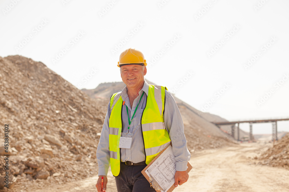 Businessman and worker reading blueprints on site Businessman and worker reading blueprints on site