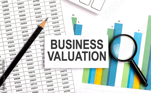 BUSINESS VALUATION text on white card on the chart background