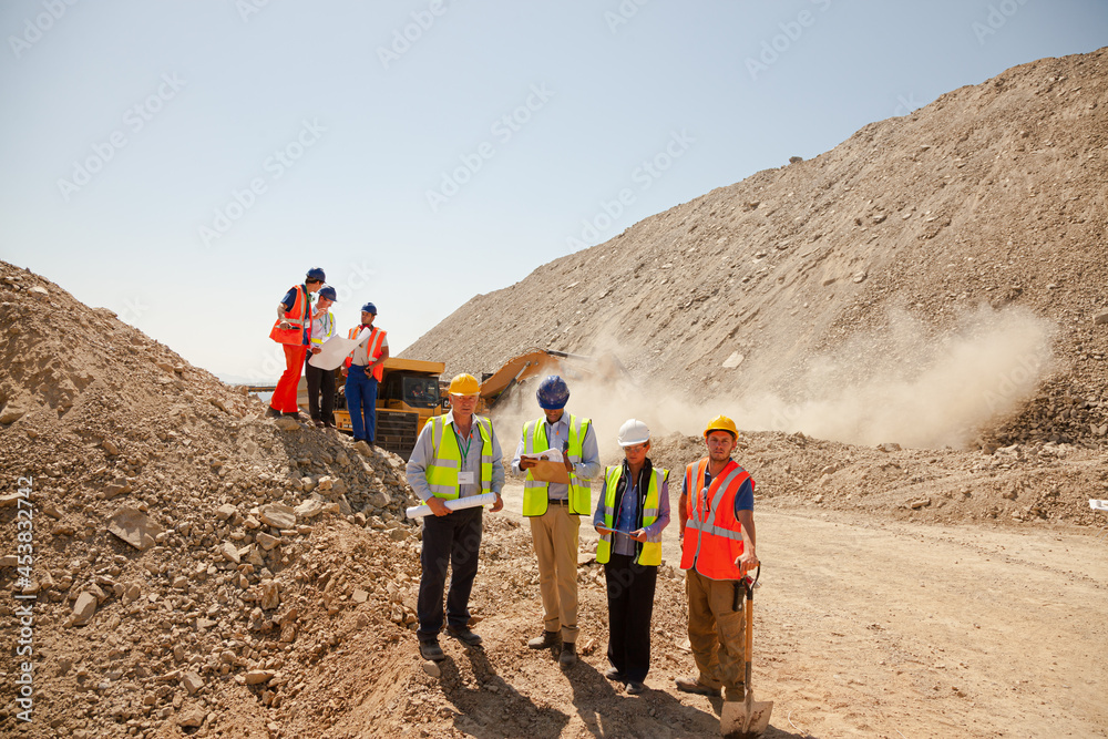 Workers and business people smiling at quarry