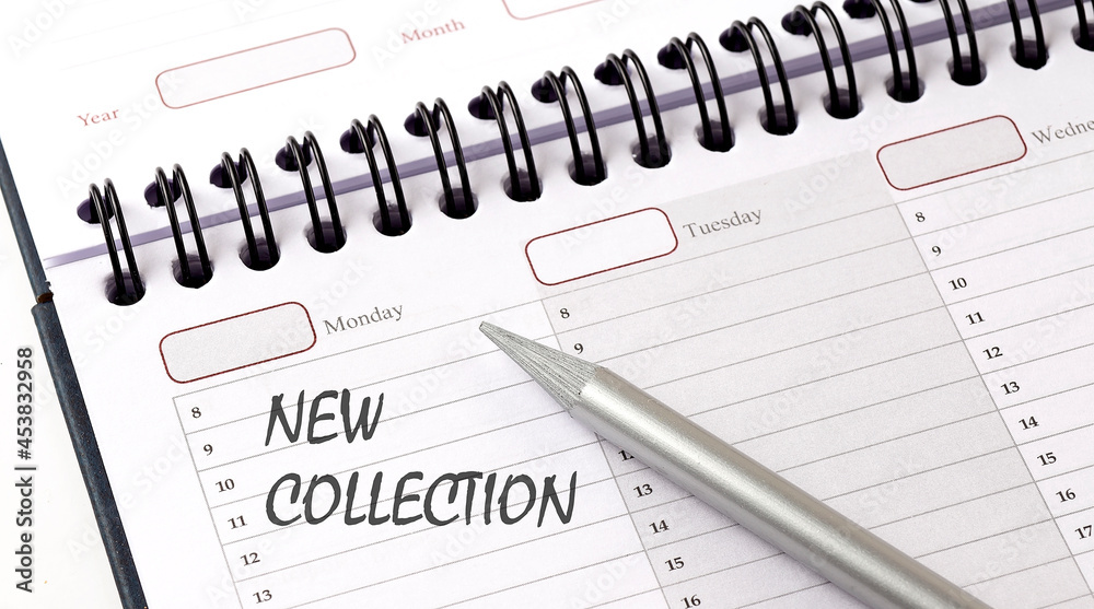 NEW COLLECTION on the planner with pencil, business concept NEW COLLECTION on the planner with pencil, business concept