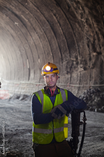 Businessman and worker standing in tunnel