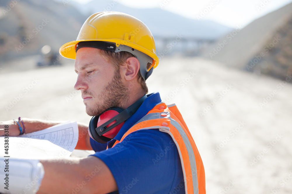 Workers reading blueprints on site Workers reading blueprints on site