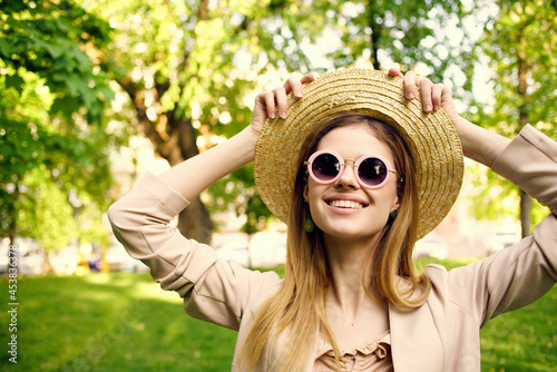 woman sunglasses and a hat in the park green grass