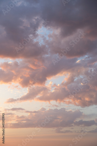 Purple cumulus funny clouds in the sunset sky