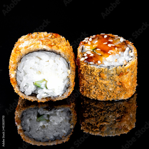 Pair of sushi on black background with reflection