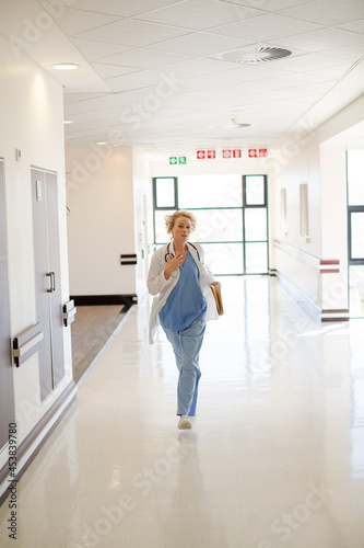 Doctor rushing down hospital corridor