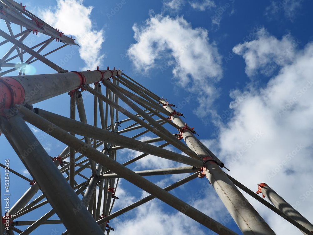 view of the structure from below, looking from above, sky with nice clouds, clear sky, and sun rays interesting angle, construction industry, iron concrete view of the structure from below, looking from above, sky with nice clouds, clear sky, and sun rays interesting angle, construction industry, iron concrete