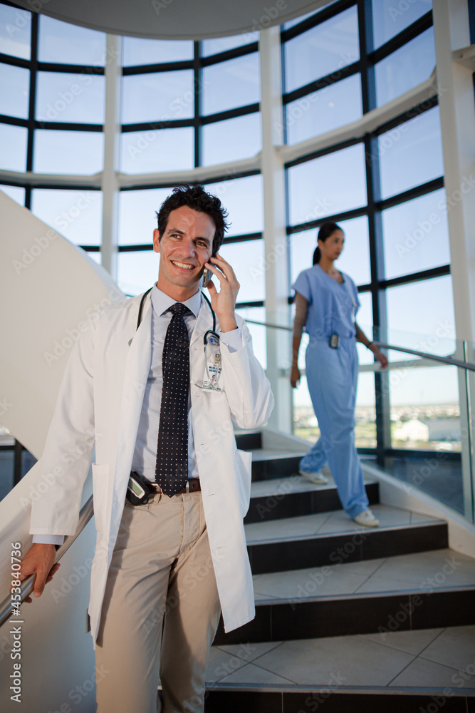 Doctor talking on cell phone in hospital