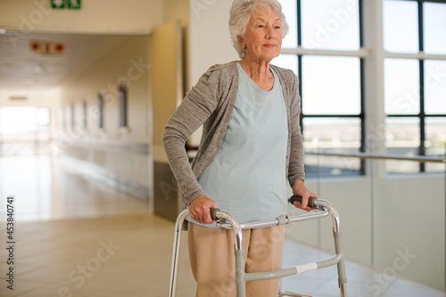 Senior patient using walker in hospital