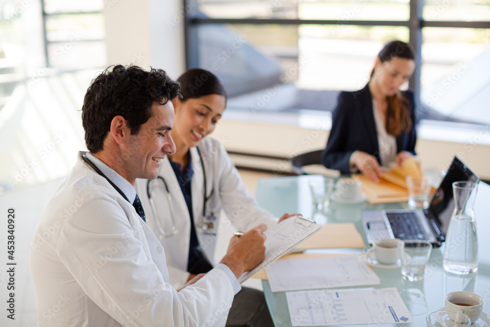 Doctors and businesswoman talking in meeting