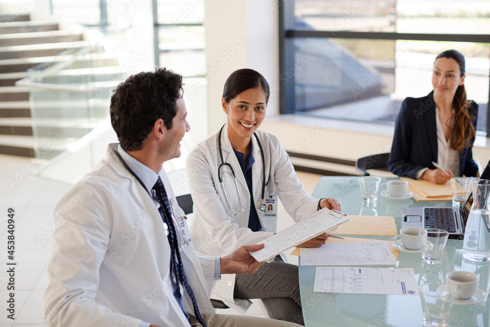 Doctors and businesswoman talking in meeting Doctors and businesswoman talking in meeting