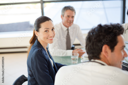 Doctors and businesswoman talking in meeting