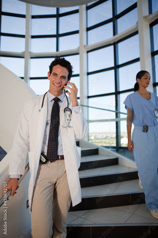 Doctor talking on cell phone in hospital