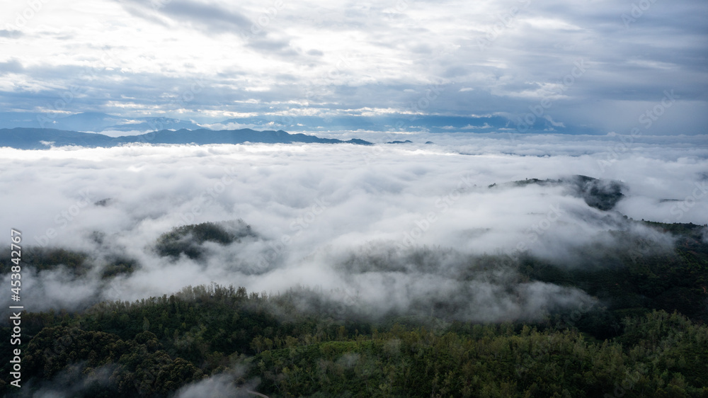 Obraz premium aerial view of clouds on beautiful mountains beautiful nature that covers the fertile tropical forests of Nan Province Northern Thailand, Ya Luang Suan