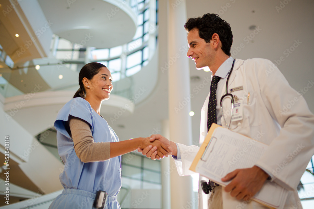 Fototapeta premium Doctor and nurse handshaking in hospital