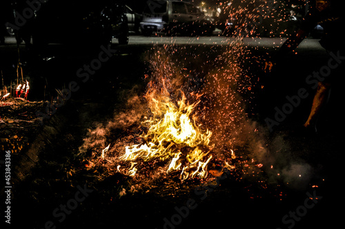 Chinese hungry ghost festival burning flame fire glowing ashes firefly colourful variety prayer paper joss money fake currency joss stick mini fag food fruit