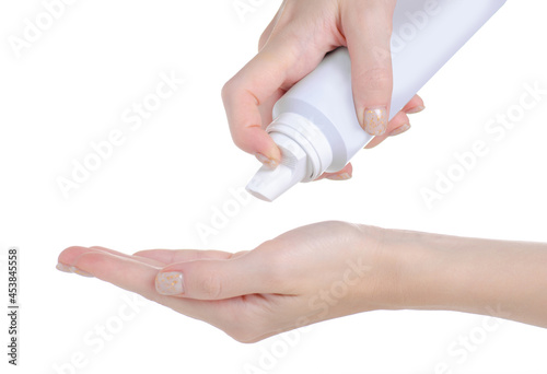 Bottle of spray hair foam in hand on white background isolation