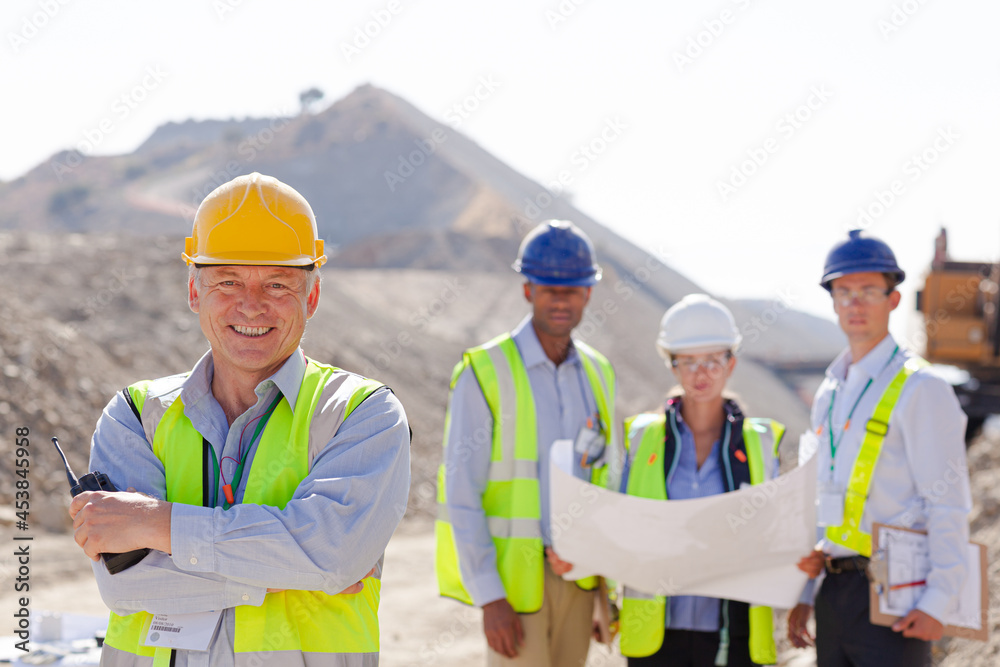 Business people and workers talking in quarry