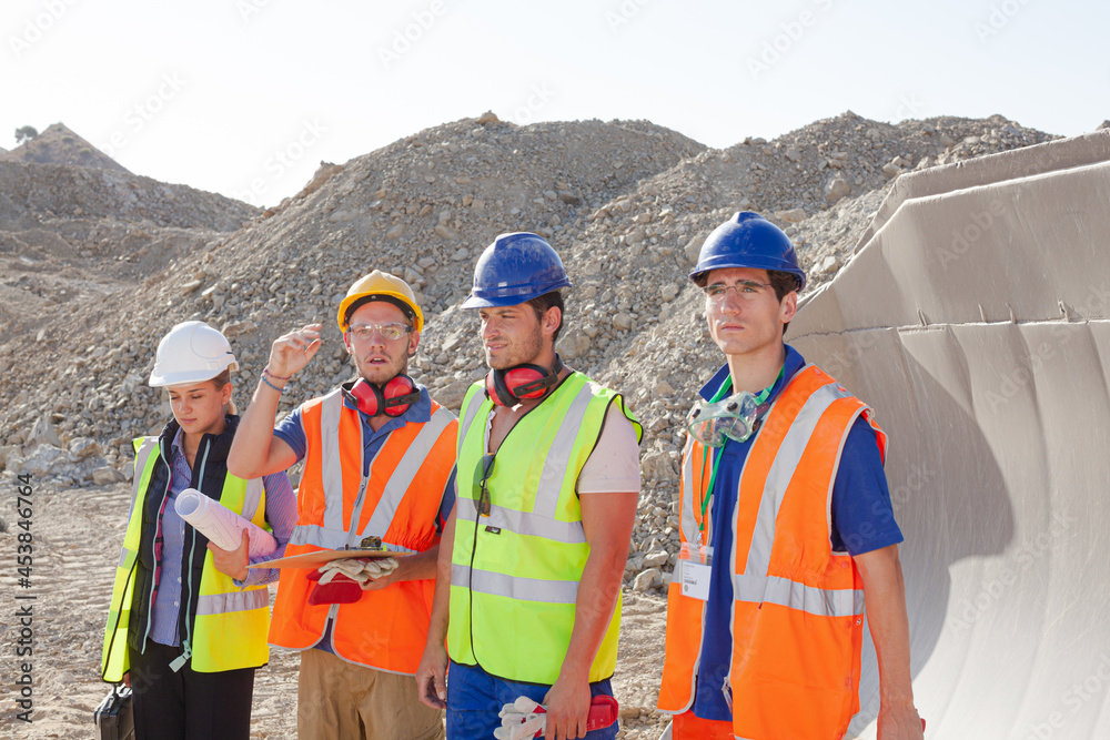 Business people and workers talking in quarry Business people and workers talking in quarry