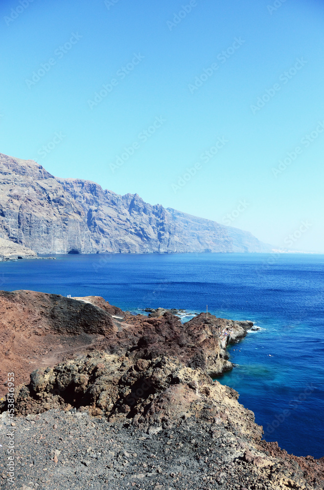 TENERIFE, SPAIN: Scenic seashore view of Los Gigantes ancient rocks with blue sea waters