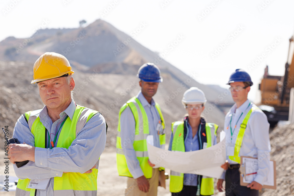 Business people and workers talking in quarry Business people and workers talking in quarry