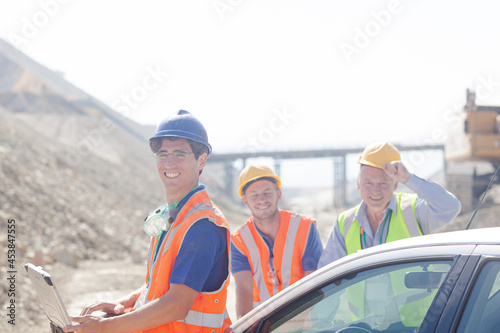 Workers and businessman standing in quarry