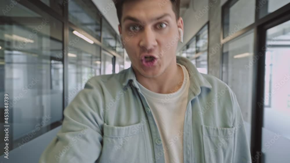 Aggressive businessman with earphones talking to employee online, stress at work Aggressive businessman with earphones talking to employee online, stress at work