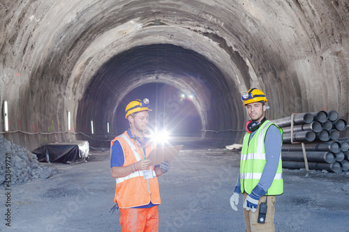 Business people reading blueprints in quarry