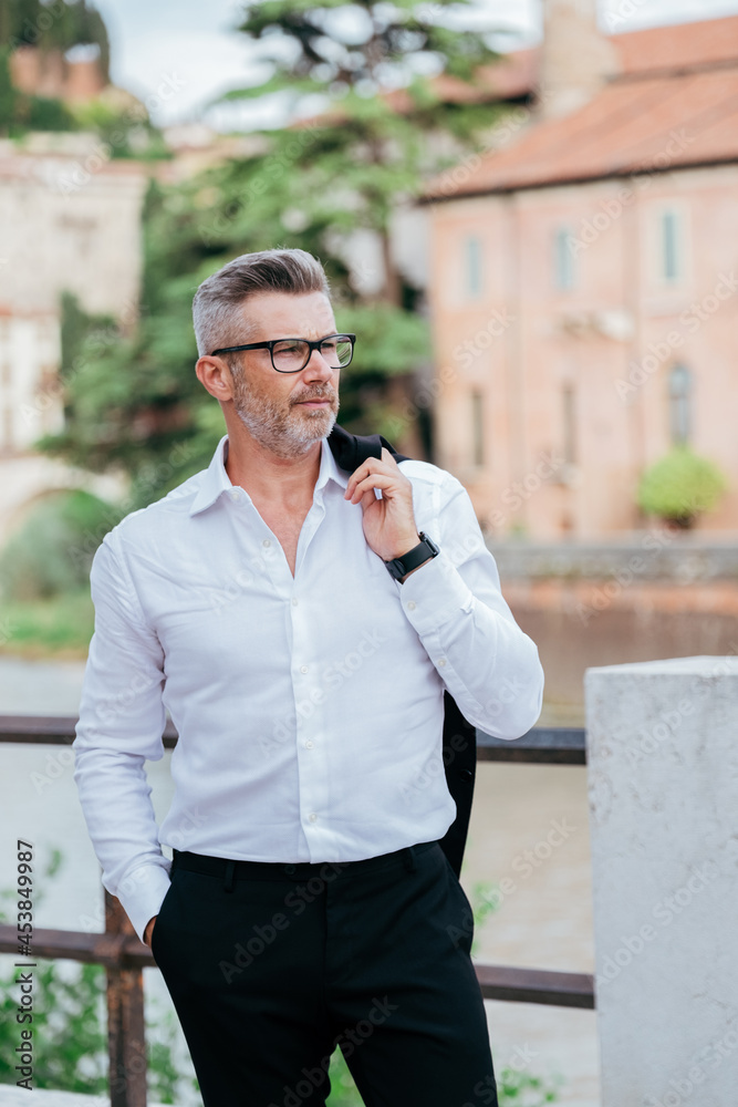 Portrait of a confident mature businessman standing outside Portrait of a confident mature businessman standing outside