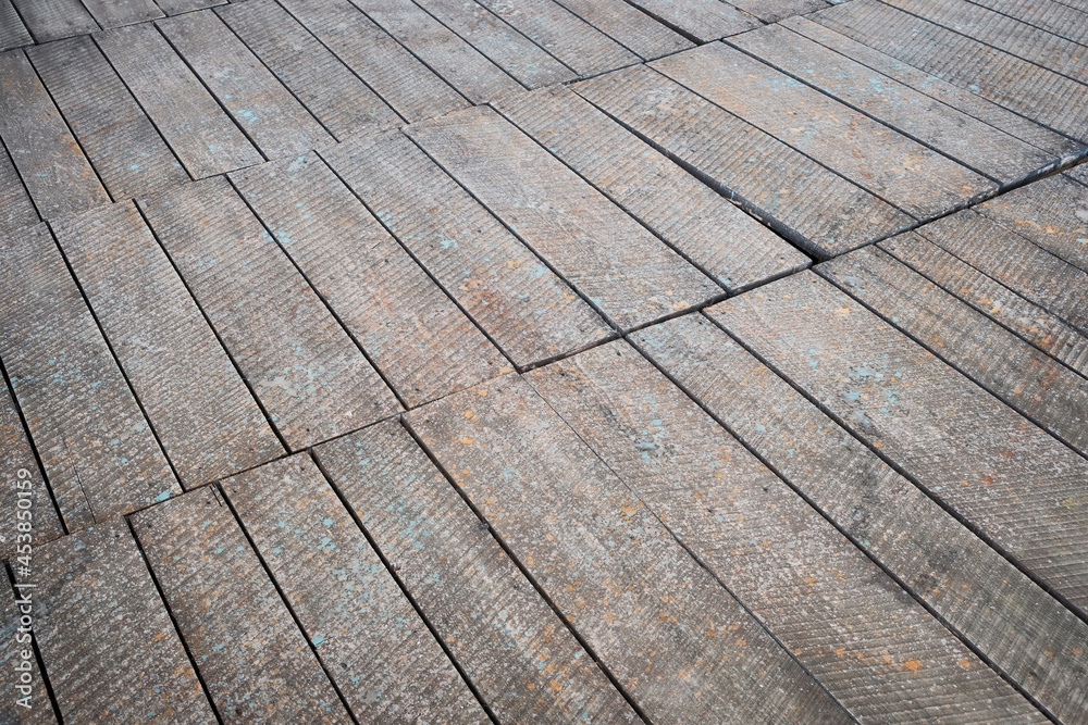 Surface of a grunge wooden floor detail in perspective Surface of a grunge wooden floor detail in perspective