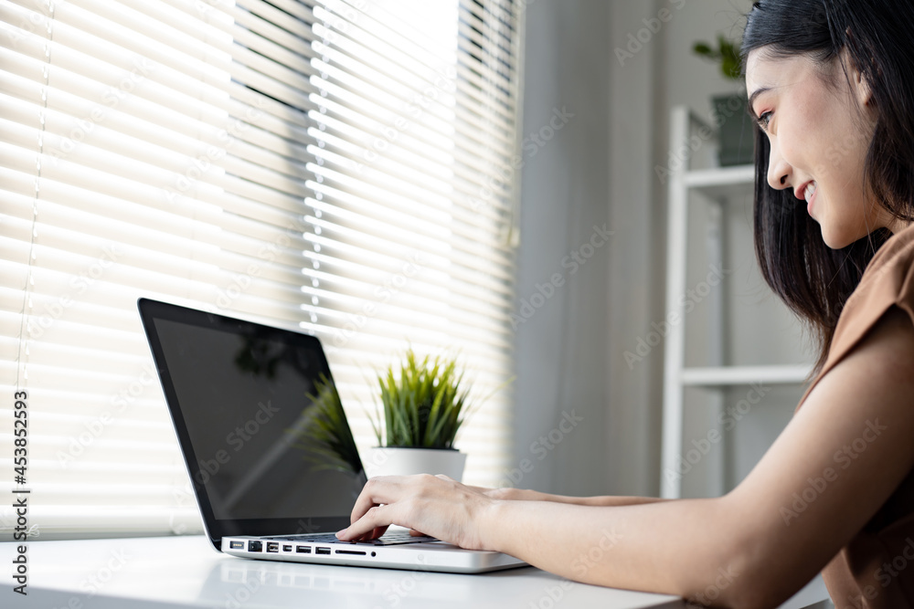 Young woman working from home by computer. Young woman working from home by computer.