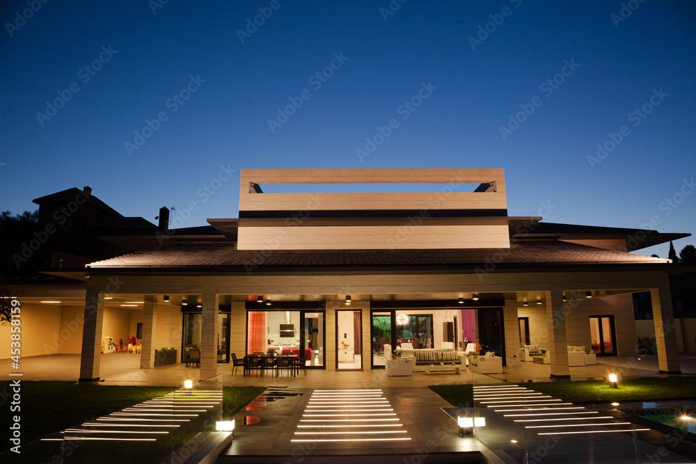 Luxury house and patio illuminated at night Luxury house and patio illuminated at night