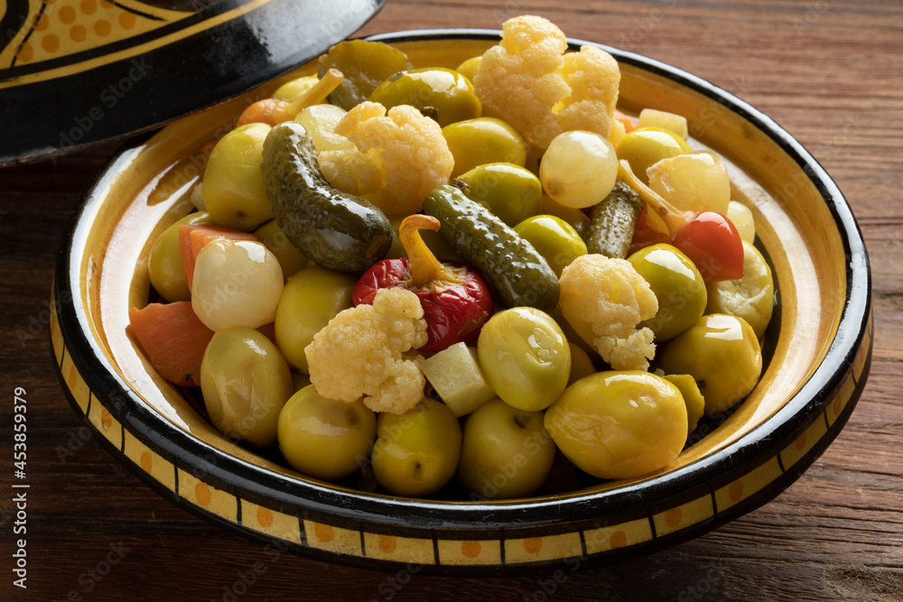 Traditional bowl with green olives and vegetables for a snack, appetizer or side dish Traditional bowl with green olives and vegetables for a snack, appetizer or side dish