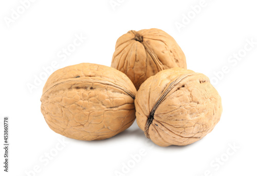 Whole walnuts in shell on white background