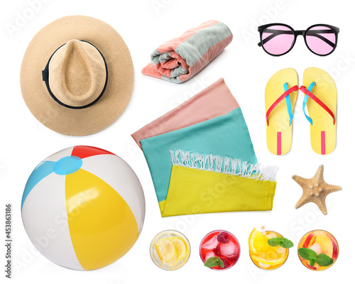 Set with towel and other beach accessories on white background