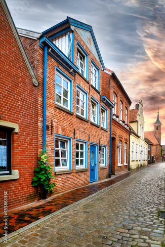 Traditional Brickhouse with blue and white windows in a norrow street in Leer  East Frisia  Germany
