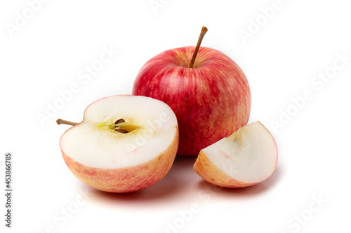 One colorful pink apple with half an apple on a white background. photo