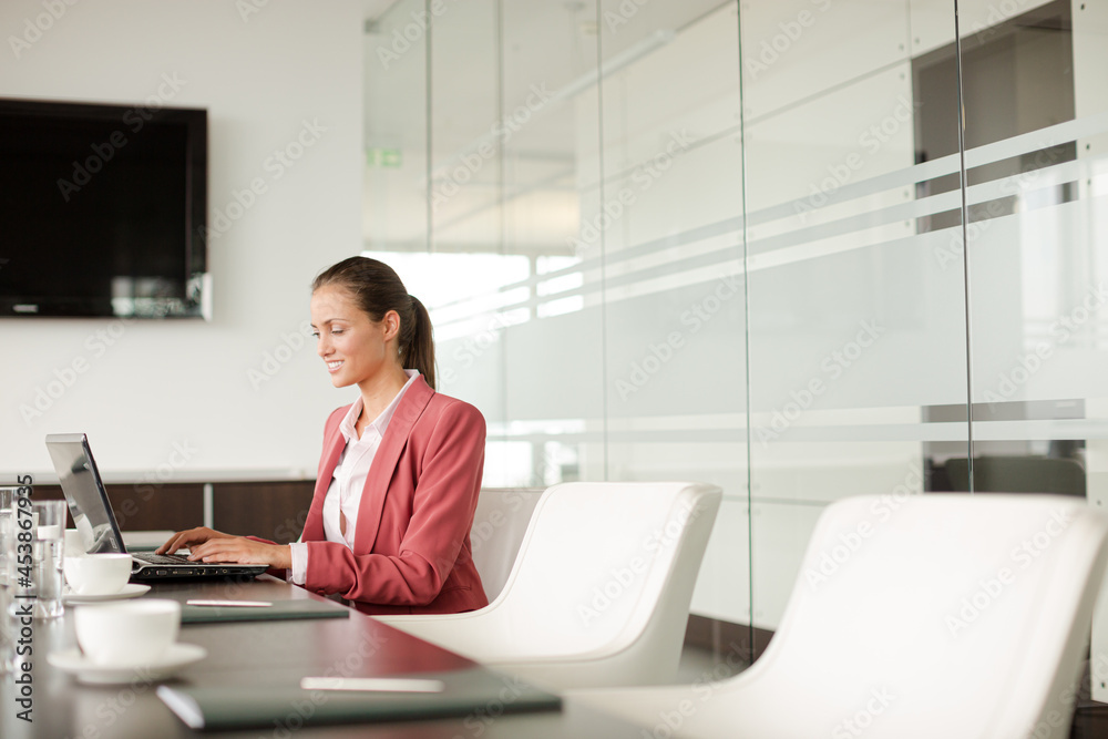 Businesswoman working at computer at desk Businesswoman working at computer at desk