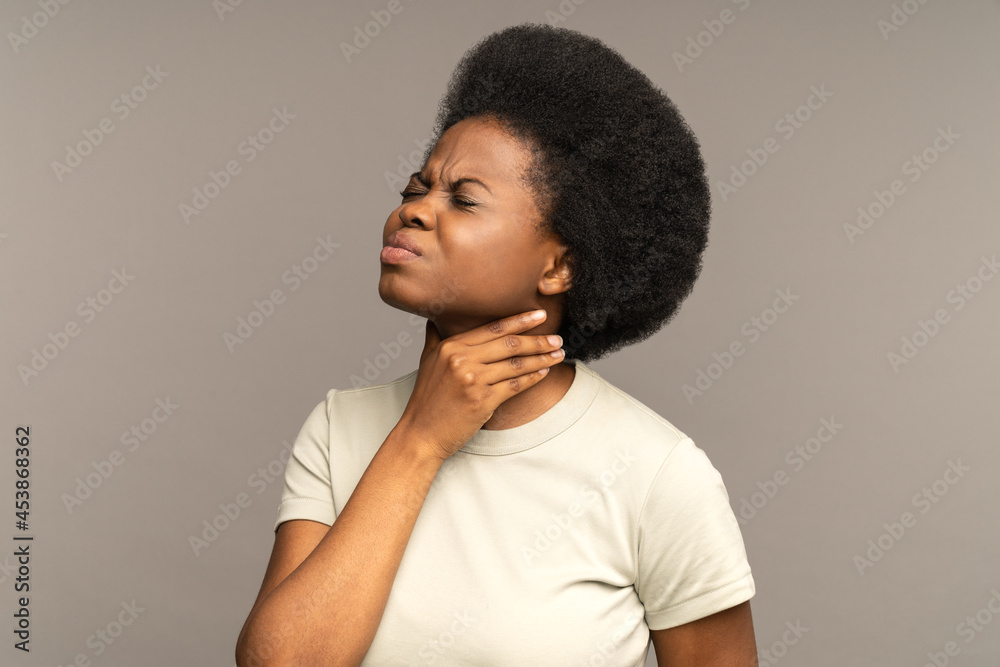 Unhealthy african girl having sore throat, suffering from painful