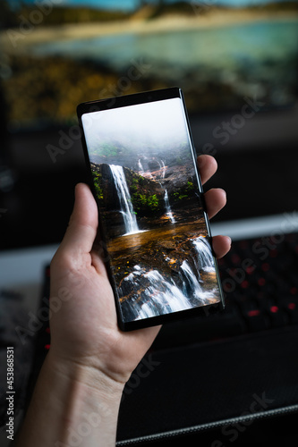 holding a phone in my homeoffice setup.