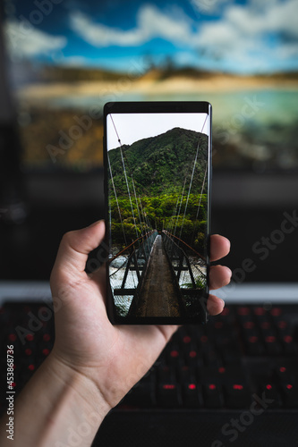 holding a phone in my homeoffice setup.
