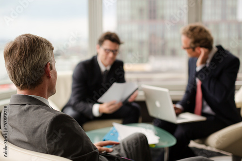 Businessmen sitting in meeting