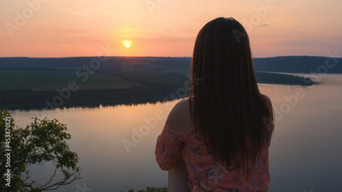 The woman sitting on rocky mountain above the beautiful river © DK