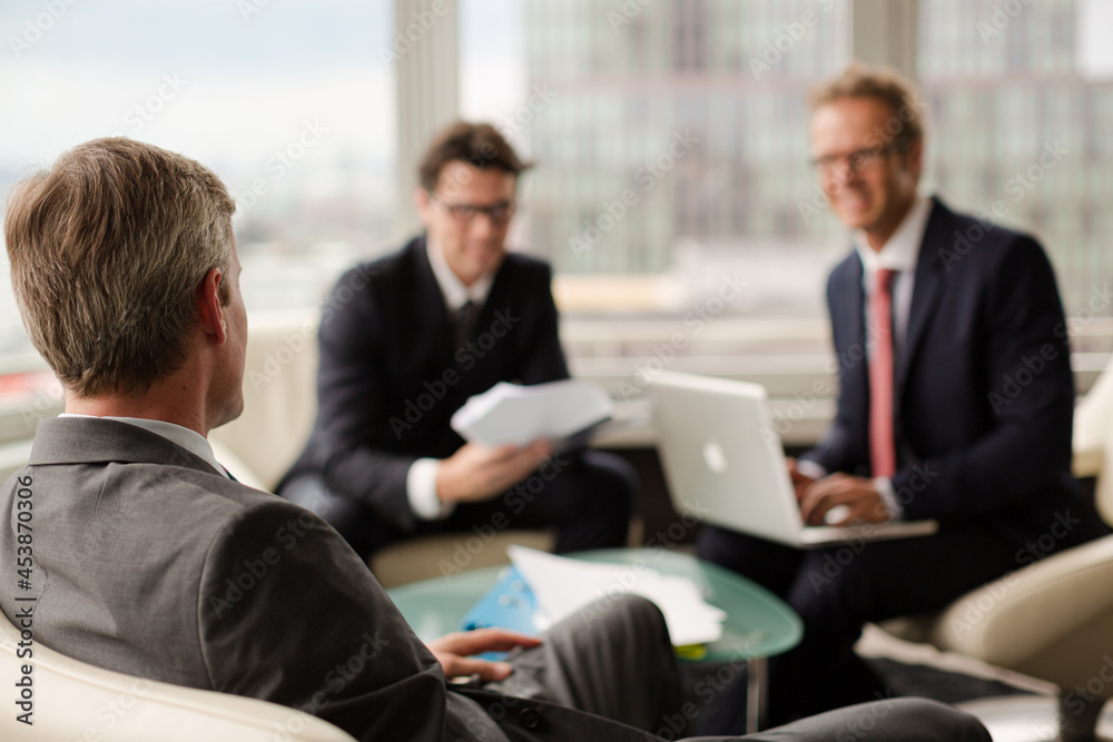 Businessmen sitting in meeting